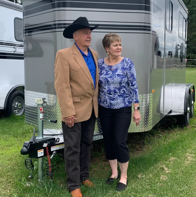 Horseman Trailer Sales owners Ray and Jean Reimann standing beside a horse trailer